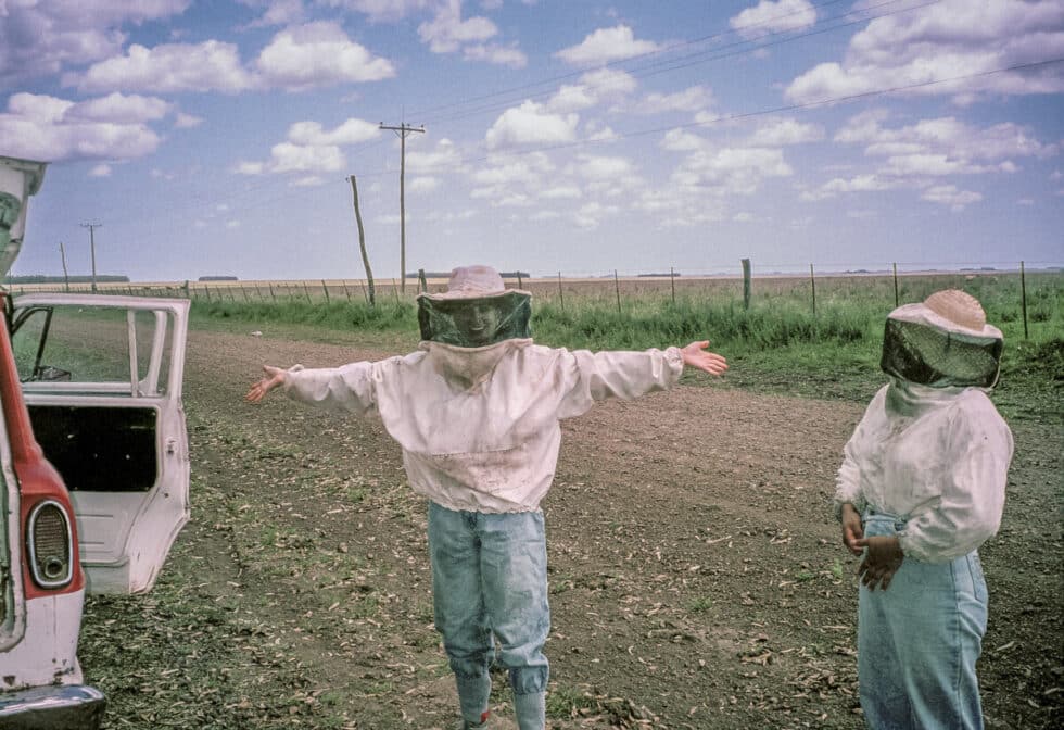 Dressed in protective gear to help tend bee hives.