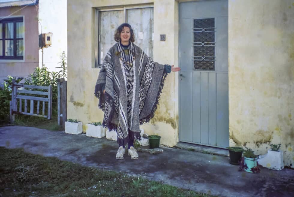 Standing in front of my home, La Casa Amarilla, wearing the poncho Marita made for me. A Peace Corps volunteer’s story in Baltasar Brum, Uruguay.